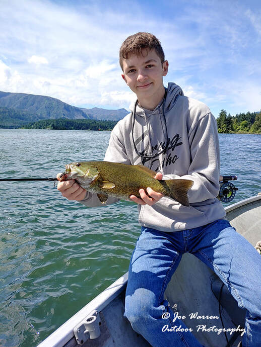 Fly fisherman and smallmouth bass on the Columbia River