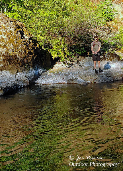 dry fly fisherman fishing for trout on a nice pool